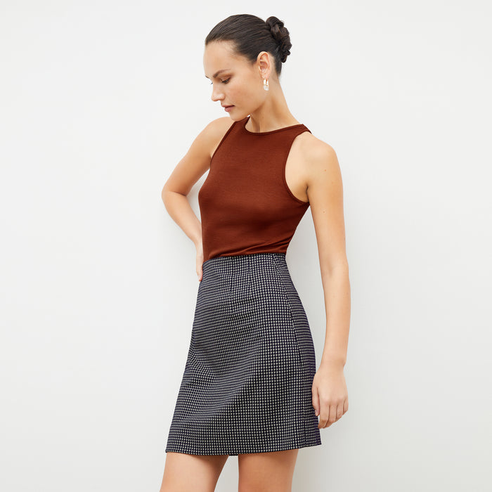 Front image of a woman wearing the whitney skirt in black and white