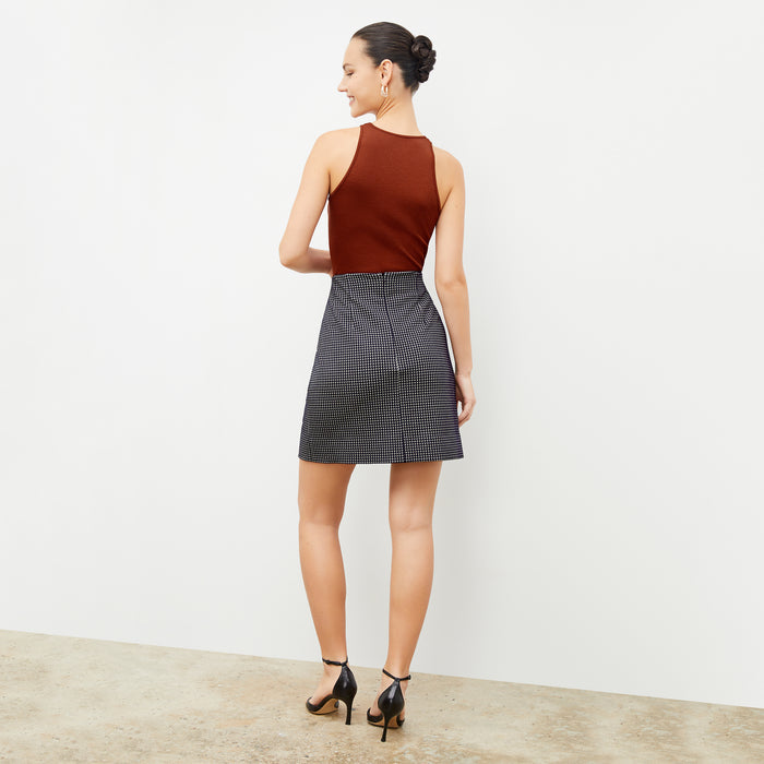 Back image of a woman wearing the whitney skirt in black and white