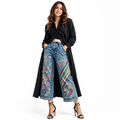 Women's embroidered wide leg denim capri pants on model with floral details and cropped silhouette