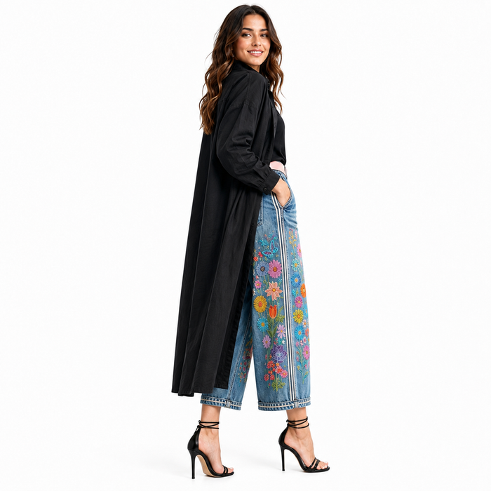 Women's embroidered denim capri pants side view on model showing cropped wide leg shape and floral details