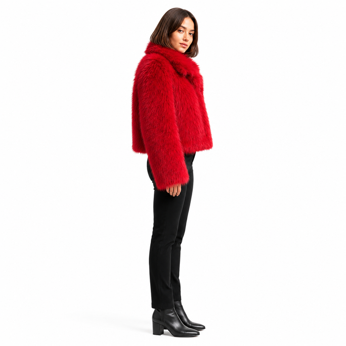 Women's red cropped faux fur jacket on a professional model, side view showing cropped hem, long full sleeve and wide collar.