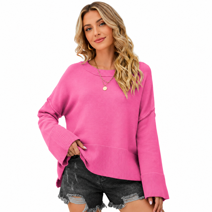 Women's pink flare sleeve sweater shown close up with dropped shoulders, ribbed neckline, wide cuffs and textured hem on white