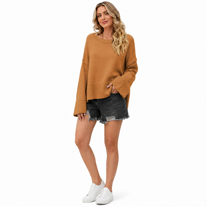 Women's camel dropped shoulder sweater with flare sleeves, ribbed cuffs and hem styled with dark denim shorts on white background