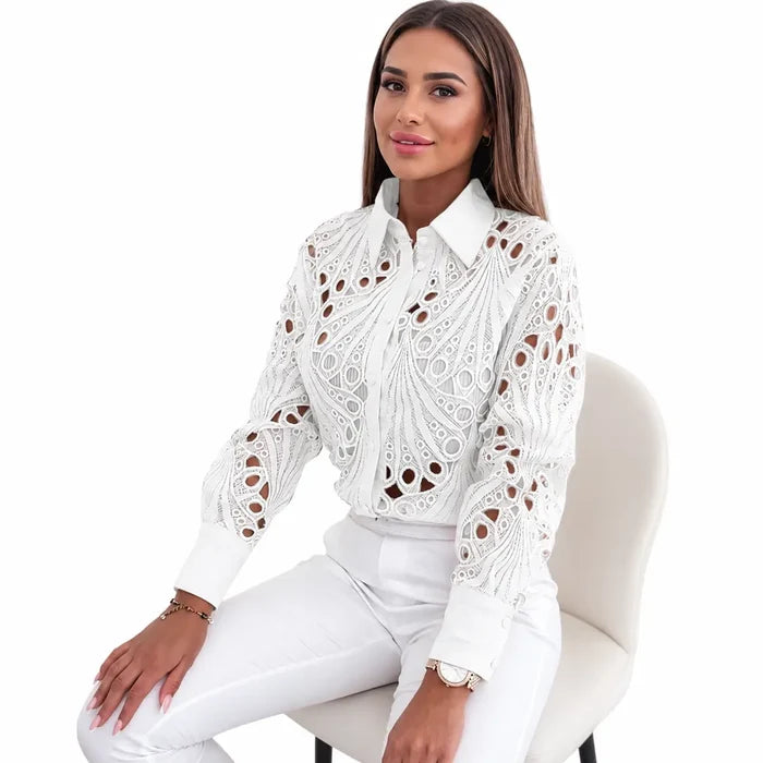 Women's white lace hollow-out long sleeve shirt shown seated on a female model with clear collar, cuffs and lace details now.