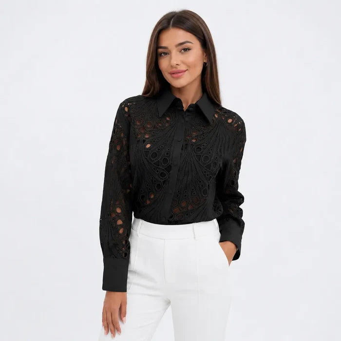 Women's black lace hollow-out long sleeve shirt worn with white trousers by a female model for refined office outfits online.