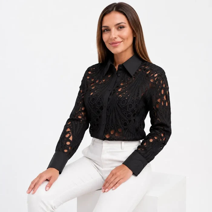 Women's black lace hollow-out long sleeve shirt shown seated, with the collar, cuffs and cutout pattern clearly visible well.
