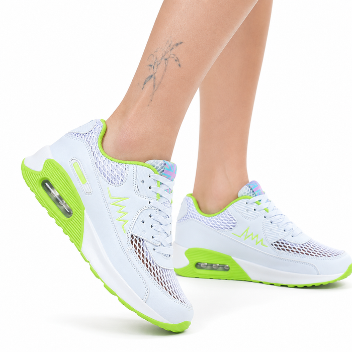 Women's running shoes white and neon green variant close-up showing mesh upper and sole details.