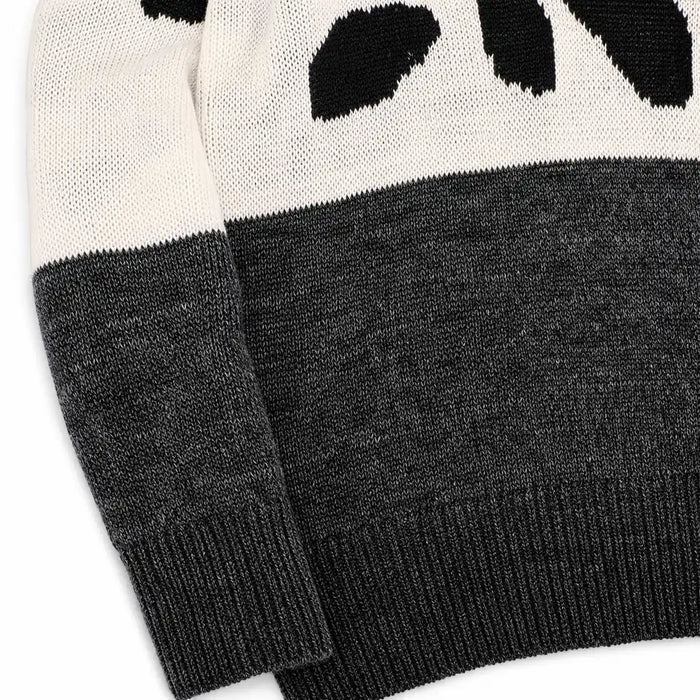 Close view of the Black and Gray leopard print sweater knit texture, color transition, ribbed cuff and lower hem.