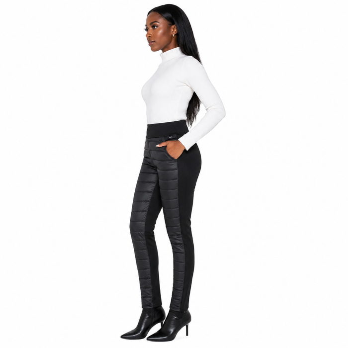 Women's black quilted pants in side view showing high waist styling, front panel detail, plain side section and tapered legs.