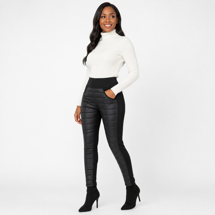 Women's black quilted pants three-quarter view showing high waist styling, quilted front panels, side sections and long legs.