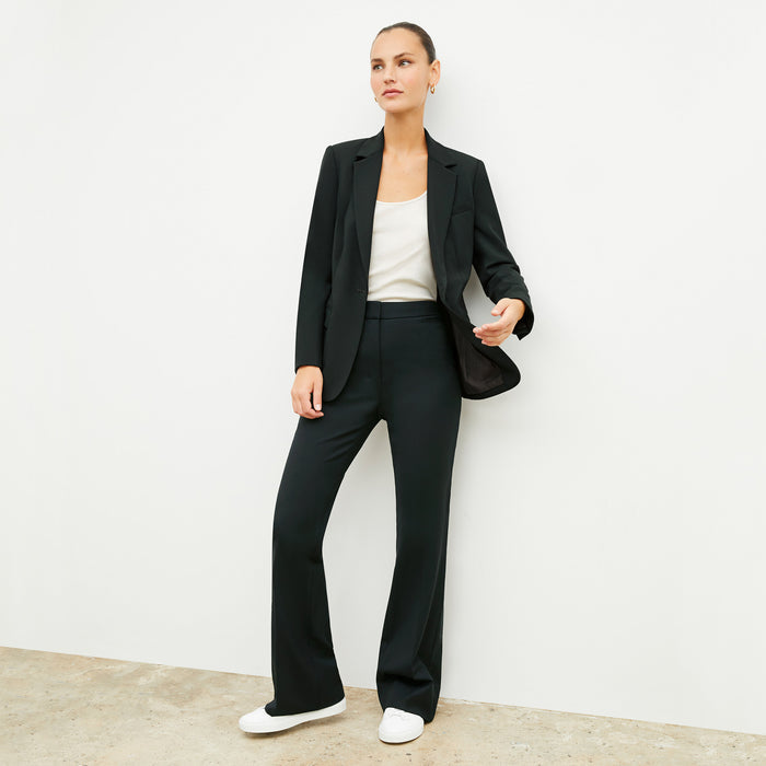 Front image of a woman wearing the yiyan blazer in forest