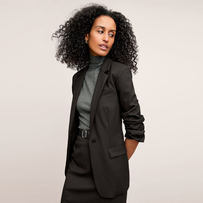 Front image of a woman standing wearing the Yiyan Blazer in Black | Lead