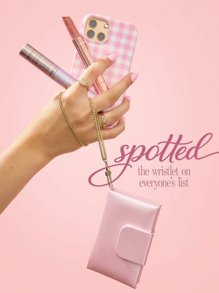 woman holding tarte cosmetics you know you love me XOXO set, wristlet attached to her