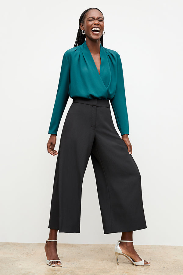 Front image of a woman standing wearing the Zhou culotte in black | Exclude