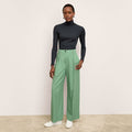 front image of a woman wearing the zuri pants in parisian green | Lead