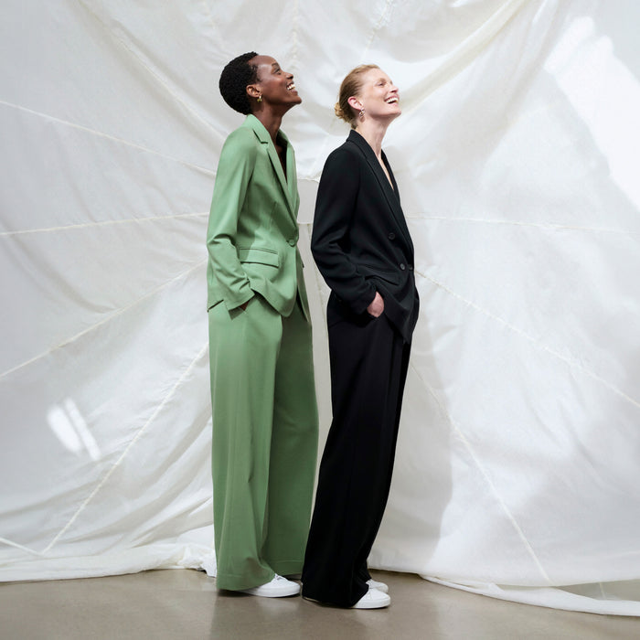 front image of a woman wearing the zuri pants in parisian green